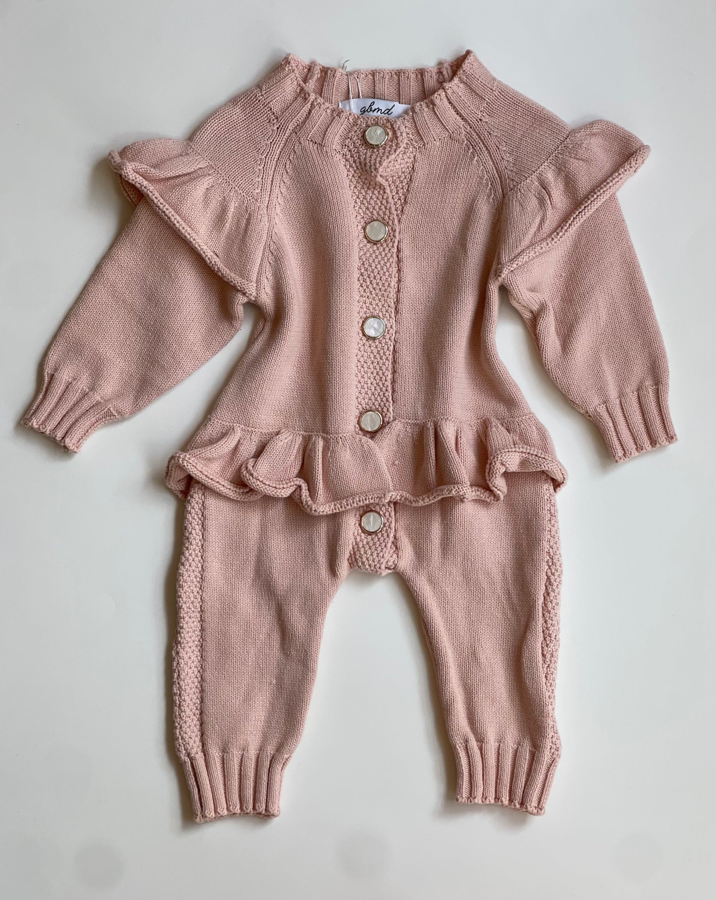 Light pink romper with buttons/ruffles